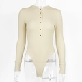 Close-up of beige ribbed bodysuit with long sleeves and gold buttons on the neckline - S / Apricot