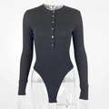 Detail of black ribbed knit bodysuit featuring a Henley neckline with silver metal buttons - S / Black