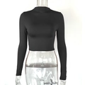 Detail view of the sleek black cropped long sleeve top with slim fit and mock neckline - S / Black