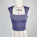 Detail view of a navy blue square neck crop top made from elastic knit fabric - S / Blue Gray