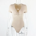Detail of beige ribbed bodysuit showing the V-neck twist design on a clear mannequin - S / Apricot