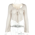 Detail of beige ribbed knit top featuring drawstring V-neck and flared sleeves - XS / Apricot