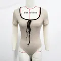 Detalle de body de canalé color albaricoque con ribetes negros y cordones en el frente - S / Albaricoque