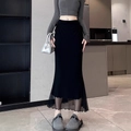 Detail of black fishtail skirt featuring sheer tulle patchwork and a wavy hemline design - S / Black