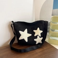Black canvas tote bag featuring decorative plush cream stars and adjustable crossbody strap - Black
