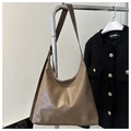 Close-up of vintage brown PU leather shoulder bag with decorative stitching details - Khaki
