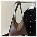 Detail of vintage dark brown tote bag with premium oil wax leather texture and chic stitching - Coffee