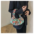 Close-up of a floral scrunchie handle bag featuring vintage green and red bloom patterns - Green Floral