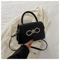 Elegant black leather handbag with rhinestone bow, crossbody strap and single handle - Black