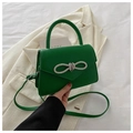 Detail of green leather handbag featuring a sparkling rhinestone bow buckle decoration - Green