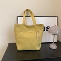 Casual mustard yellow canvas tote bag with functional front zipper and rope detail - Yellow