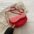 Elegant red saddle bag with diamond quilting and decorative gold chain trim - Red