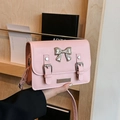 Pink crossbody bag with metal bow and vintage buckles in a stylish preppy design - Pink