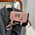 Pink and black colorblock crossbody bag with large silver bow and buckled straps - Pink and Black