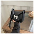 Chic black PU leather saddle bag with silver bow accent and adjustable shoulder strap - Black