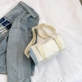 Cylindrical crossbody bag in beige and light blue canvas featuring dual buckle closure - Blue