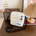 Petit sac bandoulière en toile blanche avec sangle noire et étiquette fashion - Noir