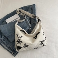 Off-white canvas hobo tote with black floral butterfly embroidery and wide strap - Beige Base Black Embroidery
