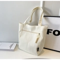 Detail of off-white canvas tote bag featuring thick rope zipper pull and fashion woven label - Off White