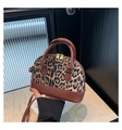 Detail of leopard print seashell handbag with brown leather base and golden hardware - Brown