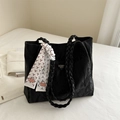 Minimalist black tote bag with woven handles and white floral scarf in a 2024 trendy style - Black