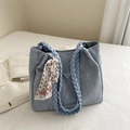 Light blue pleated tote bag with woven handles and a decorative silk scarf accessory - Blue
