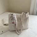 Beige tote bag with woven straps, wrinkled texture leather, and decorative silk scarf - Off White