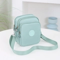 Bolso bandolera vertical de lona verde menta con múltiples compartimentos con cremallera - Verde