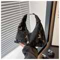 Detail of black crescent hobo bag with pleated texture and silver butterfly charms - Black