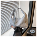Detail of light blue crescent tote with pleats and silver butterfly ornaments - Blue