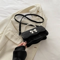 Elegant black bow-knot handbag with pearl handle and pleated texture in crossbody style - Black