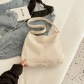Minimalist beige corduroy tote bag with long shoulder strap and front pocket detail - Off White
