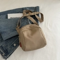 Khaki minimalist canvas crossbody bag with orange fashion label on denim background - Khaki