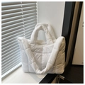 Detail of white quilted puffer bag with large square stitching and padded handle - White