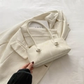 Minimalistische Achseltasche mit weißem Marmormuster und Goldlogo auf beigem Stoff - Weiß