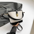 Minimalist woven bucket bag featuring elegant black and white leather contrast design - Black