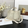 Off-white corduroy tote bag with front pockets and adjustable shoulder strap for women - Off White