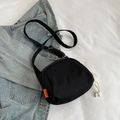 Black canvas messenger bag with orange fashion tag and plush pompom charm detail - Without Pendant / Black