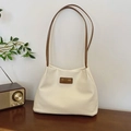Cream textured bucket bag with brown slim handles and brand leather label detail - Brown