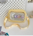 Detail of yellow canvas itabag with transparent window and cartoon rabbit badges - With Badge / Yellow