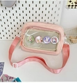 Detail view of pink transparent crossbody bag with cute badges and adjustable strap - With Badge / Pink