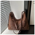 Macro detail of brown suede tote bag with bow patch and vintage lace-up elements - Coffee