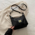 Minimalist black pleated crossbody bag with MIAO SHE logo and slim shoulder strap - Black without Charm