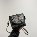 Grey leopard print bucket bag with black leather trim and gold twist lock closure - Black