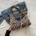 Retro leopard print tote bag with ruffled handle and side tie detail on denim background - Khaki