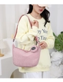 Pink corduroy hobo bag and small round coin purse worn by model in a cozy home setting - Pink