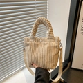 Beige corduroy bucket bag with ruched handle and canvas strap in a cozy indoor setting - Off White