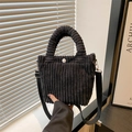 Black corduroy bucket tote bag with plush texture and adjustable shoulder strap - Black