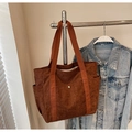 Detail of brown corduroy tote bag with front pocket and durable woven shoulder straps - Dark Brown