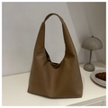 Grand sac hobo marron tissé disposé sur une table avec lampe design et croissant - Kaki